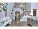 Inviting foyer features hardwood floors and staircase with iron railings at 116 Chorley Run, Ellenwood, GA 30294