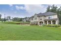 Expansive front yard and landscaped lawn, with traditional two-story home in background at 116 Chorley Run, Ellenwood, GA 30294