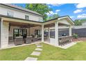 Outdoor patio with a dining area, built in grill, ceiling fans, stone walkway, and manicured backyard at 1442 Pierce Se Ave, Smyrna, GA 30080