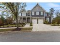 Charming two-story home with stone accents, well manicured yard, and inviting front porch at 3198 Garden Hill Ln, Douglasville, GA 30135