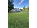 Large lawn with home, driveway, and cars at 102 Bascomb Drive Dr, Woodstock, GA 30189