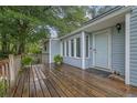 Inviting front porch with wooden deck and lovely plants, creating a warm welcome at 102 Bascomb Drive Dr, Woodstock, GA 30189