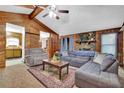 Cozy living room with wood paneling, a stone fireplace, and comfortable seating arrangement at 102 Bascomb Drive Dr, Woodstock, GA 30189