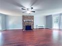 Spacious living room features a stone fireplace, wood floors, and ample natural light at 3460 Ebenezer Rd, Marietta, GA 30066