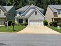 Charming two-story home with a well-manicured lawn and a two-car garage at 264 Ascott Ln, Woodstock, GA 30189