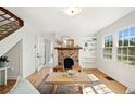 Inviting living room with a stone fireplace, hardwood floors, and bright natural light at , Atlanta, GA 30344