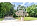 Attractive two-story home with lush green lawn and mature trees at 4335 Burgomeister Pl, Snellville, GA 30039