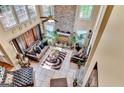 Bright living room with a stone fireplace, tile floors, and large windows that offer great natural light at 4335 Burgomeister Pl, Snellville, GA 30039