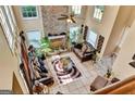 Open living room featuring a stone fireplace and comfortable seating arrangement at 4335 Burgomeister Pl, Snellville, GA 30039