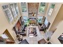Bright open floor plan featuring a floor-to-ceiling fireplace, tile floors, and large windows at 4335 Burgomeister Pl, Snellville, GA 30039