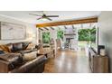 Bright and airy living room featuring hardwood floors, beamed ceilings and exposed brick fireplace at 687 Monticello Se Way, Marietta, GA 30067