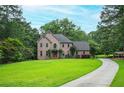 Elegant brick home with a large front yard and long drive at 13789 Woolsey Rd, Hampton, GA 30228