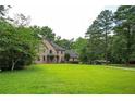 Spacious home with a well-maintained lawn and mature trees at 13789 Woolsey Rd, Hampton, GA 30228
