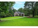 Beautiful brick home with a long driveway and lush green lawn at 13789 Woolsey Rd, Hampton, GA 30228