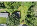 Aerial view of a private backyard oasis surrounded by lush trees with a deck at 2600 Sandpiper Dr, Tucker, GA 30084