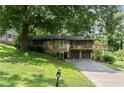 Beautiful home featuring stone accents, a two-car garage, and a spacious deck nestled amongst mature trees at 2600 Sandpiper Dr, Tucker, GA 30084