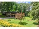 Beautiful home with lush greenery and a mature tree in the front yard at 2600 Sandpiper Dr, Tucker, GA 30084