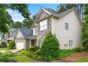 Charming two-story home featuring brick and stone accents, a well-manicured lawn, and a two-car garage at 58 Lilyfield Ln, Acworth, GA 30101