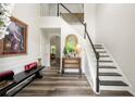Bright foyer features hardwood floors, a staircase with black and white risers, and elegant decor at 58 Lilyfield Ln, Acworth, GA 30101