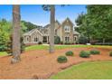 Charming home with a manicured front lawn, complemented by mature trees and lush landscaping at 245 Maple Shade Dr, Tyrone, GA 30290