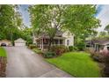 Charming home featuring a screened-in porch, lush landscaping, and a detached garage at 4520 Dallas St, Acworth, GA 30101