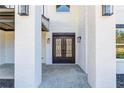 Elegant wrought iron double front doors and stone columns, complemented by modern exterior lighting at 0 Thompson Mill Rd, Buford, GA 30519
