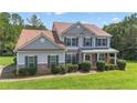Charming two-story home with stone accents, manicured lawn, and covered front porch at 102 Plantation Dr, LaGrange, GA 30277