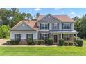 Charming two-story home with stone accents, manicured lawn, and covered front porch at 102 Plantation Dr, LaGrange, GA 30277