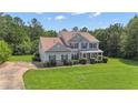 Beautiful two-story home featuring a well-manicured lawn and driveway at 102 Plantation Dr, LaGrange, GA 30277