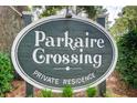 Community sign reading Parkaire Crossing Private Residence nestled among lush greenery at 1301 Parkaire Xing, Marietta, GA 30068