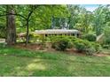 Traditional single-story brick home nestled among mature trees and greenery at 1618 Mason Mill Ne Rd, Atlanta, GA 30329