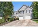 Traditional home showcasing a two-car garage and wood staircase at 40 Browning Dr, Covington, GA 30016