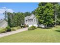 Inviting home featuring a well-maintained lawn and mature trees at 40 Browning Dr, Covington, GA 30016