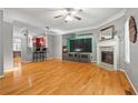 Open-concept living room with hardwood floors, fireplace, and bar seating area at 406 Heritage Park Nw Trce # 22, Kennesaw, GA 30144