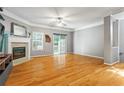 Spacious living room features hardwood floors, fireplace, and natural light from sliding door at 406 Heritage Park Nw Trce # 22, Kennesaw, GA 30144