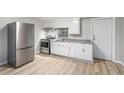 Bright kitchen with stainless steel appliances, granite countertops, and white cabinets, providing a modern cooking space at 1328 Eason Nw St, Atlanta, GA 30314