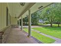 Inviting covered front porch with brick detailing, supporting columns, and a view of the landscaped yard at 1724 Rhonda Ln, Stone Mountain, GA 30087