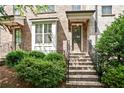 Inviting brick townhouse with a covered entrance and manicured landscaping at 3657 Atherton Park Ct, Suwanee, GA 30024