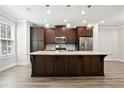 Stylish kitchen with a large center island and dark wood cabinetry at 3657 Atherton Park Ct, Suwanee, GA 30024