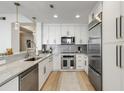 Modern kitchen with white cabinetry, granite countertops, and stainless steel appliances at 2795 Peachtree Rd # 1305, Atlanta, GA 30305