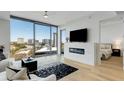 Open living room with modern fireplace, flat screen television, and floor to ceiling windows at 2795 Peachtree Rd # 1305, Atlanta, GA 30305