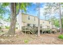 Backyard view of a townhome with a private wooden deck and natural surroundings at 3403 Spring Harbour Drive Dr, Doraville, GA 30340