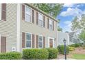 Traditional-style townhome with neat landscaping, well-maintained siding, and matching dark brown shutters at 3403 Spring Harbour Drive Dr, Doraville, GA 30340