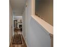 Inviting hallway with wood floors leads to a cozy living area featuring a fireplace and staircase at 3403 Spring Harbour Drive Dr, Doraville, GA 30340