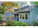 Charming exterior view of the home highlighting architectural details and beautiful landscaping in a wooded setting at 3531 Evans Ridge Dr, Atlanta, GA 30341