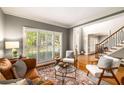 Inviting living area with hardwood floors, plantation shutters, and a staircase in view at 6211 Traymore Se Trce, Smyrna, GA 30082