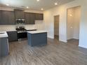 Well-lit kitchen features stainless steel appliances, a center island, and plentiful cabinet space at 777 Oakmont Trce, Canton, GA 30114