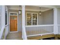Welcoming front porch featuring stylish lighting, wood flooring and wood door at 1240 Oakland Sw Ter # B, Atlanta, GA 30310