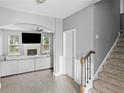 Bright living room featuring a fireplace, ceiling fan, and staircase at 133 Worthing Ln, Fairburn, GA 30213
