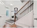 Inviting foyer with a staircase, bench seating, hardwood floors, and ample natural light at 490 Duval Dr, Alpharetta, GA 30009